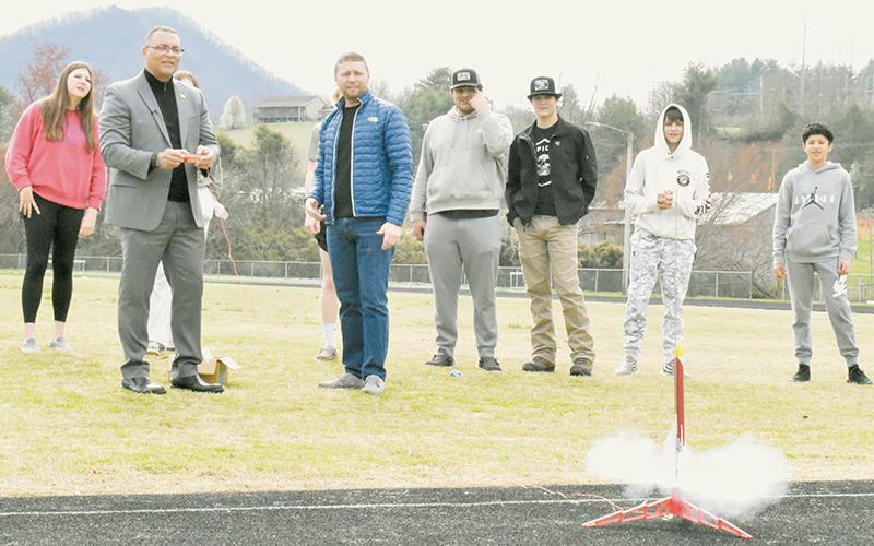 Robbinsville High School STEM Teacher Ben Davis looks on as Burroughs Wellcome Fund Senior Communications Officer Alfred Mays prepares to launch a model rocket built by senior Lorin Hogsed on March 9. Slow-motion video of the demonstration is available on both The Graham Star’s Facebook and Instagram accounts.