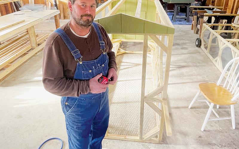 Keith McAlum builds portable chicken coops in shop space off Long Branch Road near Robbinsville. Photo by Randy Foster/Cherokee Scout