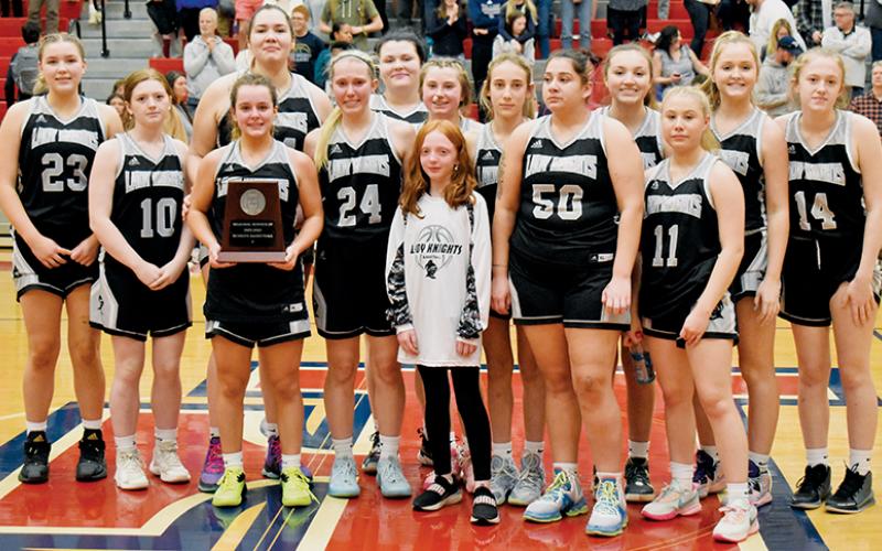 The Robbinsville Lady Knights were understandably distraught while accepting the 1A Western Regional Runner-Up plaque after dropping the game 41-30 to Bishop McGuinness. All names are listed from left. Front row: Desta Trammell, Kensley Phillips, Bella Ford, Fala Welch and Suri Watty. Back row: Liz Carpenter, Olivia Lewis, Aubrie Wachacha, Bentley Riggs, Abby Wehr, Anna Williams, Katie-Lyn Gross, Anna York and Maleah Cox. Photos by Kevin Hensley/sports@grahamstar.com