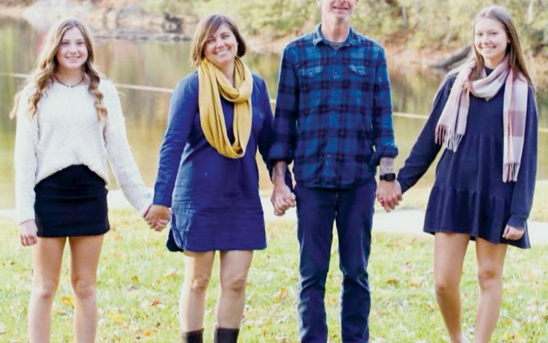 The Wehr family enjoyed a fall photoshoot on the shores of Lake Santeetlah, soon before Jessica and Aron traveled to Mexico for stem-cell therapy that the family hopes will dispose of Aron’s multiple sclerosis. Also pictured are the couple’s daughters: Abby (left) and Anna. Photo courtesy of Miranda Moody Photography