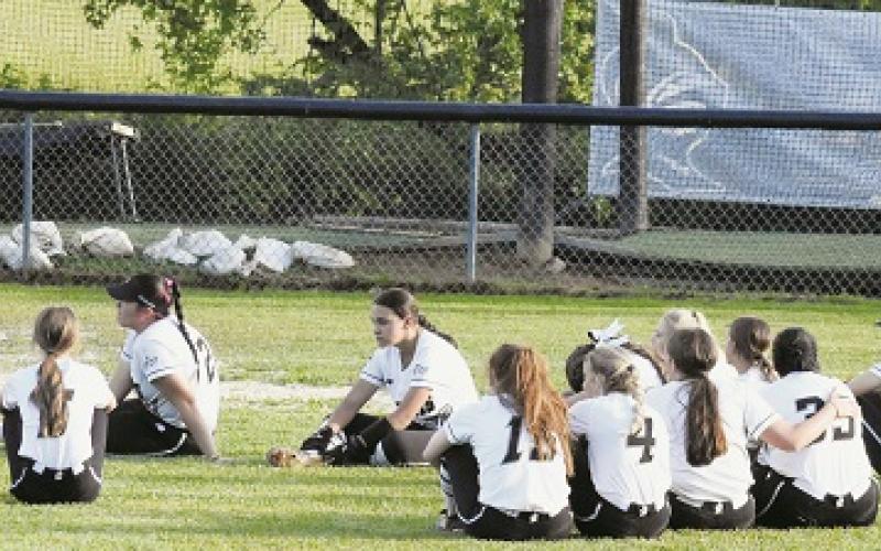 Despondent, the Robbinsville Lady Knights gather in left field for the final post-game meeting of the season May 17, following their third-round playoff exit at the hands of Union Academy. Photos by Montana Buchanan/The Graham Star