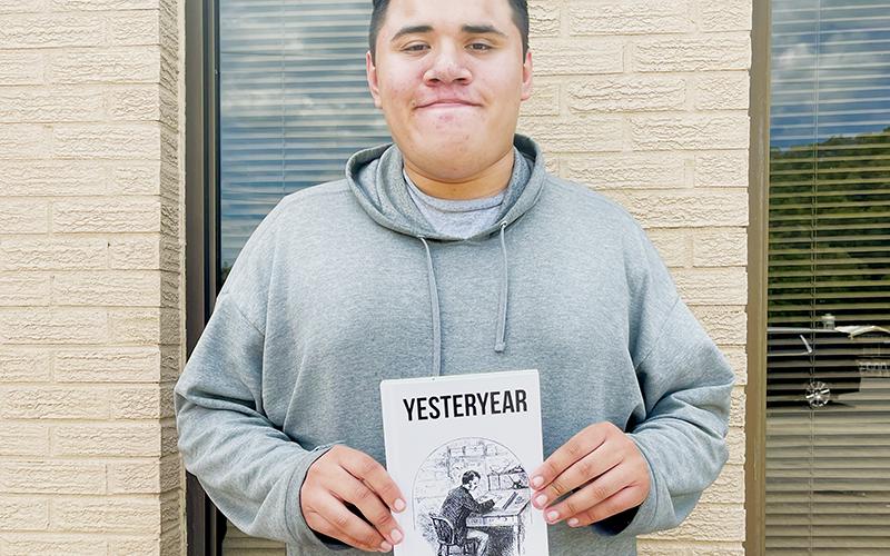 Robbinsville High School senior Skylar Jerkins shows off his debut novel, Yesteryear. Photo by Latresa Phillips/The Graham Star
