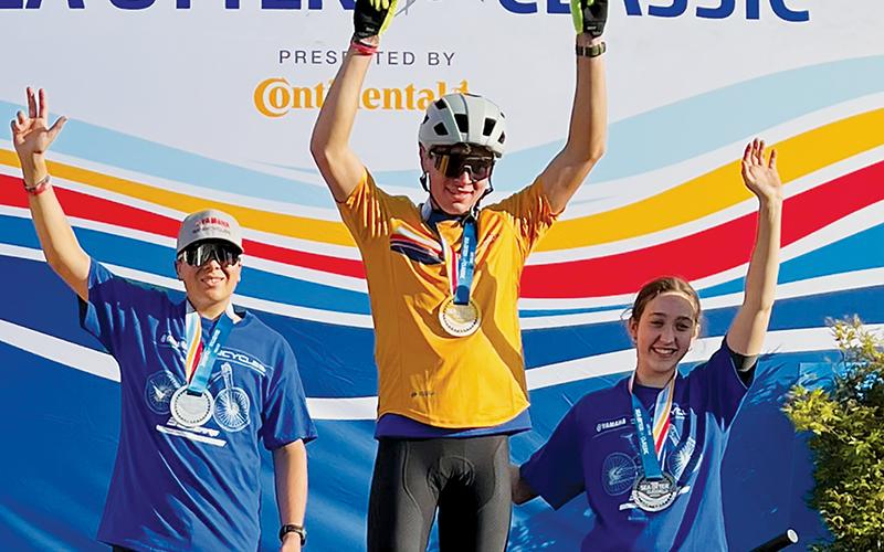 Snowbird native Ty Teasdale stands on the podium after winning the Grand National Cross Country Series’ Life Time Sea Otter Classic. Surrounding Teasdale are his teammates, Mitch Hawkins (left) and Ali Cardoza.