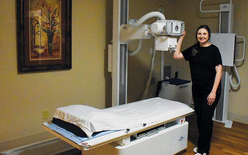 Appalachian Mountain Community Health Center’s Hannah Anderson has not stopped beaming with pride about the clinic’s new x-ray machine, which arrived earlier this month. Photo by Kevin Hensley/editor@grahamstar.com