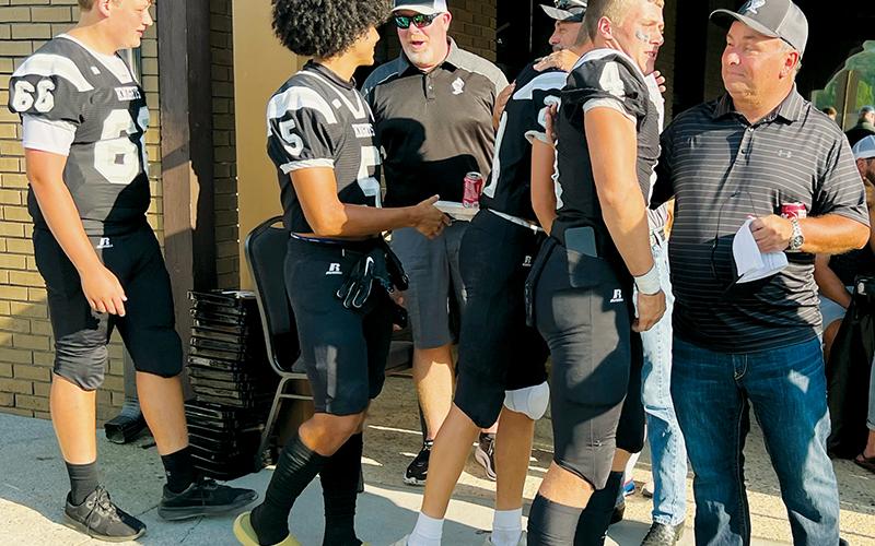 Prior to Friday’s season opener against East Surry, the Robbinsville Black Knights filed through a line to  personally thank local contractors and officials that helped complete the renovation of the home-seating area at Big Oaks Stadium in just 49 days. Players  pictured are Daegan Bird, Darion Ledbetter, Tillman Adams and Cuttler Adams (from left). Photo by Kevin Hensley/sports@grahamstar.com