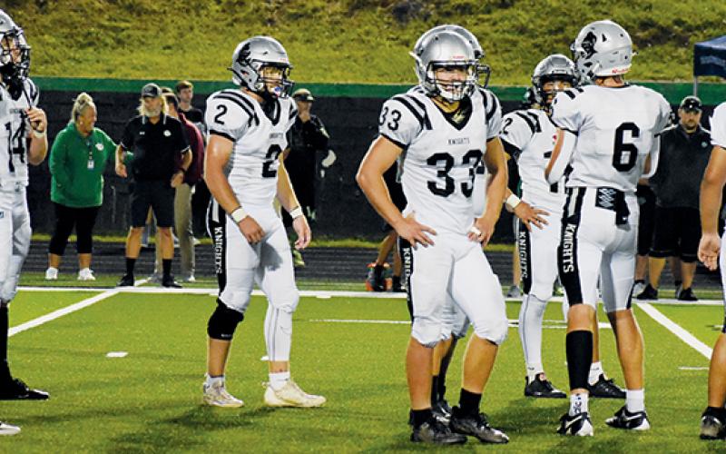 Members of the stubborn “Black Knights Swarm” await formation orders from defensive coordinator Lucas Ford at Mountain Heritage on Friday.