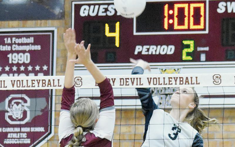 Junior Claire Barlow (3) rises above Swain County’s Kinsley Hyatt during Sept. 21’s road match in Bryson City. Photo by Kevin Hensley/sports@grahamstar.com