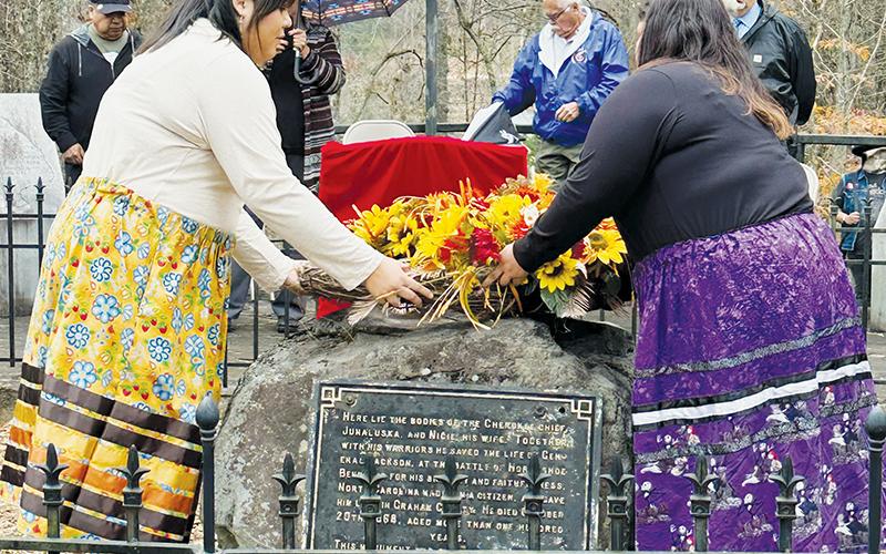 Cecilia Arrowwood (left) and Jenni Junaluska place the ceremonial wreath on Junaluska’s grave Friday. Photos by Latresa Phillips/The Graham Star