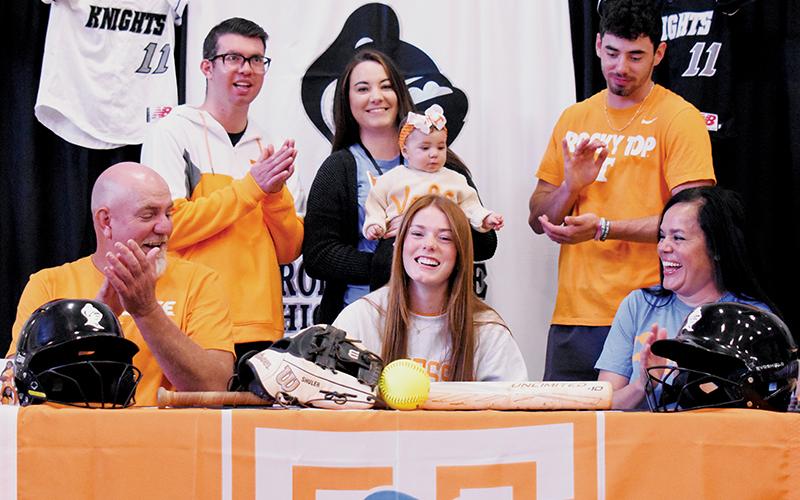 Smiles broke out all around Nov. 8, moments after Lady Knights senior Zoie Shuler signed her National Letter of Intent to play softball for the University of Tennessee. Shuler was surrounded by her father Michael (seated, left) and mother Kylie. Standing in back are her siblings: Trace, Taylor (holding Zoie’s niece Ayla) and Jeb. Photos by Kevin Hensley/sports@grahamstar.com
