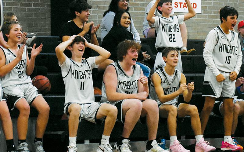 Members of the Robbinsville Black Knights erupt in celebration of Peyton Brooks’ late-game bucket in Monday’s season opener against Murphy. From left are Peyton Weaver (24), Bam Nelms (11), Landen Eddings, Eli Lambert, Carsan Snider (22) and Xamuel Wachacha (15). Photo by Kevin Hensley/sports@grahamstar.com