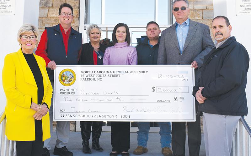 The next stop was at the Graham County Courthouse in downtown Robbinsville, where Corbin and Gillespie presented two checks. The first was a cool $2 million for the planned Graham County Justice Center. Standing in front are commissioners Connie Orr (left) and Lynn Cody. Standing in back (from left) are Corbin, county clerk Kim Crisp, commissioner Natasha Williams, Graham County Project Manager Jason Marino and Gillespie. Photo by Ruby Annas/news@grahamstar.com