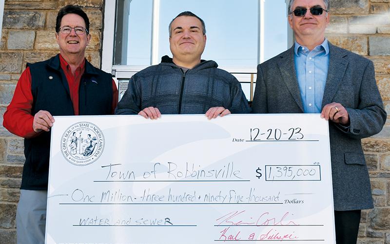 Corbin and Gillespie then presented Town of Robbinsville Mayor Shaun Adams with a check for $1.395 million, to go toward water and sewer projects within the municipality. Photo by Ruby Annas/news@grahamstar.com