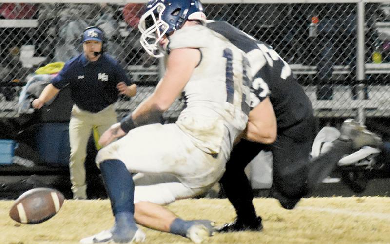 In the scramble for a fumble, Kage Williams laid a hard hit on Mount Airy’s Ian Gallimore. Photos by Fala Welch/The Graham Star