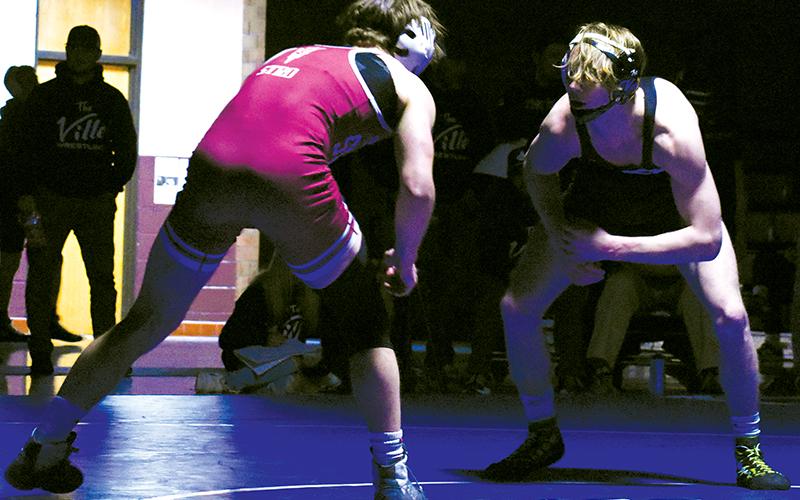 Avery Phillips sizes up James Stroman during Monday’s 138-pound segment of the Smoky Mountain Conference title match.