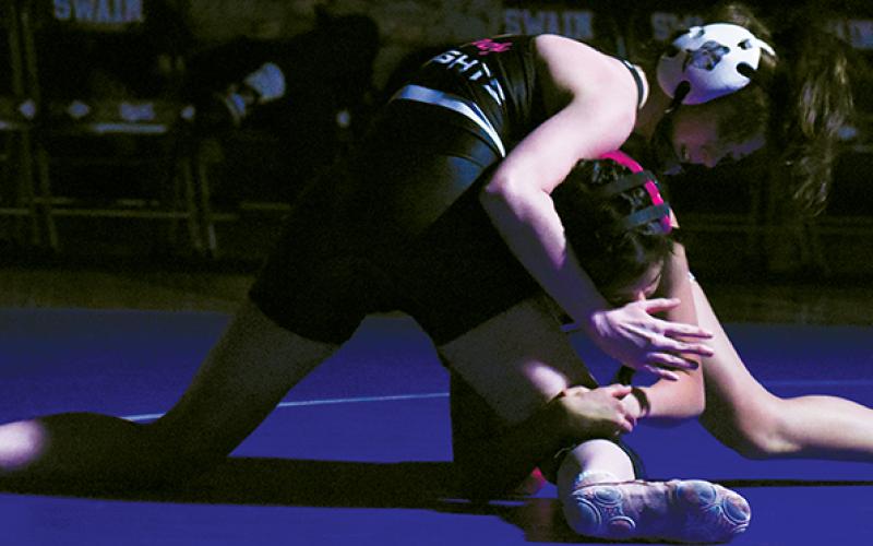 Robbinsville’s Andrea Sheeks attempts to sprawl loose from the clutches of Swain County’s Jany Echeverria during Monday’s divisional title match in Bryson City.