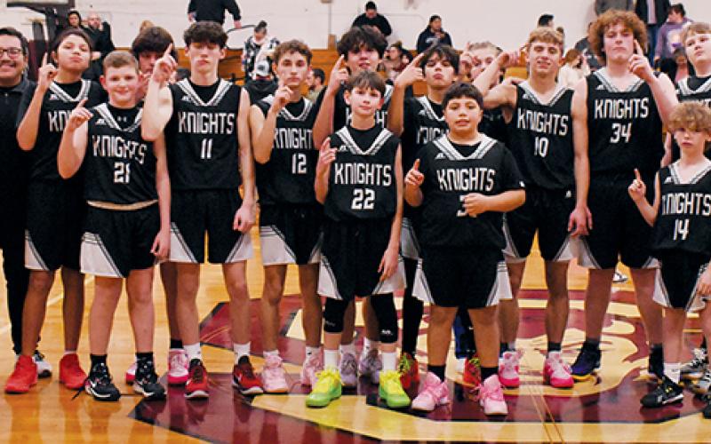 The Robbinsville Middle School Black Knights gathered at half court in Bryson City on Monday to commemorate a 14-0 regular season after defeating Swain County in the finale. Photos by Kevin Hensley/sports@grahamstar.com