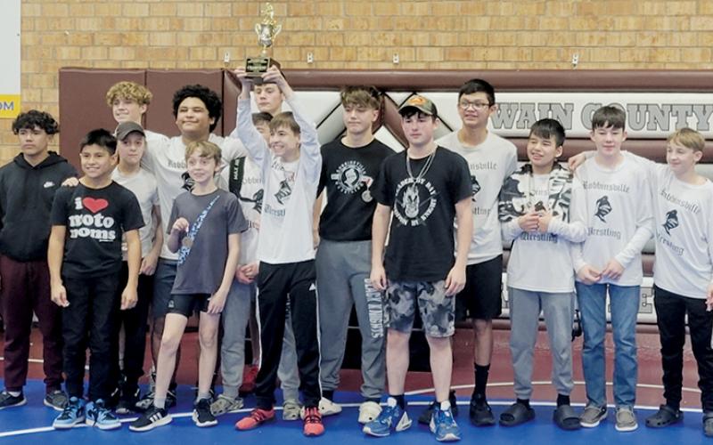 The Robbinsville Middle School Black Knights beam with pride after winning their third consecutive Smoky  Mountain Conference title Dec. 21. Photo courtesy of Robbinsville Wrestling