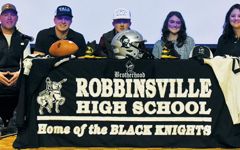 Cuttler Adams (second from left) sits with his family after committing to play football at Yale University on Feb. 7. From left are his father, Coy; brother, Tillman; sister, Chloe; and mother, Brandi.