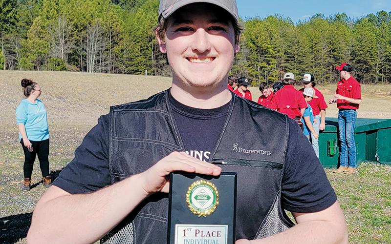 Robbinsville’s Ryan Lynn proudly displays his first place award March 16, after  winning the individual race at the district tournament in Polk County. Photo courtesy of Cheri Lynn/Robbinsville Shooting Team