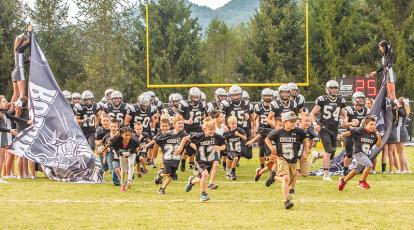 Summer youth football camp participants led the Black Knights onto the field during Youth Night on Friday. Photos by Byron Housley/The Graham Star