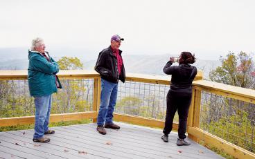 Pennsylvania residents Jo and Tony Stefanon (left, center) chat with Texas native Aja Stefanon about the breathtaking views at the Maple Springs Observation Deck. Photos by Kevin Hensley/editor@grahamstar.com
