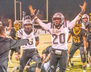 Coach Lucas Ford (left) can't contain his excitement as Clayson Lane (15) and Lex Hooper (20) rejoice in the moment Friday night at Murphy, after Robbinsville moved the chains for the final time in a Smoky Mountain Conference title-clinching 17-14 win over the Bulldogs. Photos by Byron Housley/The Graham Star