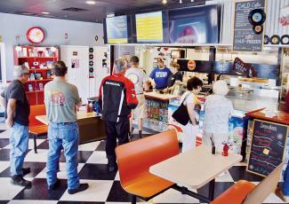 Customers eagerly await their food at The Hub on Saturday. Photos by Art Miller/amiller@grahamstar.com