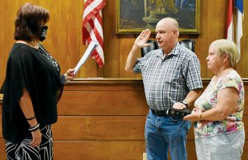 Graham County Clerk of Court Tammy Holloway (left) swears in Jerry Crisp as the new Graham County Sheriff on Tuesday afternoon. Holding the Bible is Jerry’s aunt, Janet Crisp Lequire. Photo by Kevin Hensley/editor@grahamstar.com