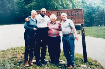 The Leary’s (couple at right) were frequently asked by travelers who stopped at Deals Gap to pause for a photograph in front of the sign outside their store, Crossroads of Time. Photos courtesy of Cathy Mathews