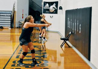 Robbinsville’s Ivy Odom (front) and Kensley Phillips work through a drill at a July 23 workout. Knights volleyball and cross-country will begin their 2020-21 season next month, but COVID-19 restrictions will keep spectators at a minimum. Photo by Kevin Hensley/editor@grahamstar.com