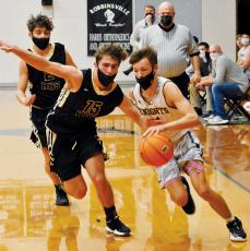 Brock Adams races past Hayesville's Brady Shook on a fast break during Friday's 60-56 loss to the Jackets. Photo by Kevin Hensley/editor@grahamstar.com