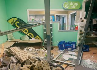 Bobby Kays has been accused of using a Graham County Sheriff’s Office vehicle to run through the front of Robbinsville Pharmacy on Saturday night. After the incident, the damaged portion was boarded up with plywood and the pharmacy reopened Monday. Photo courtesy of Robbinsville Pharmacy