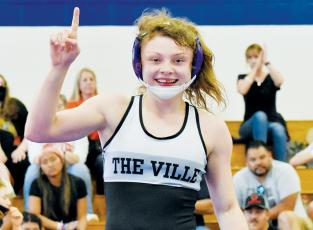 Aynsley Fink shows off a battle wound Saturday, moments after capturing the N.C. High School Athletic Association’s 106-pound championship at the Women’s Invitational in Kernersville. Photo by Kevin Hensley/sports@grahamstar.com