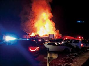 Stecoah Diner was fully engulfed Monday night, shortly after a fire started in the kitchen of the longtime local establishment. Crews deemed the structure a total loss in the wee hours of Tuesday morning. Photo by Kevin Hensley/editor@grahamstar.com