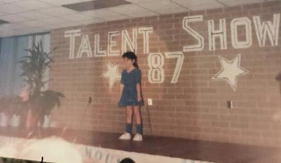 Miranda “Mandy” Millsaps (nee Seagle) was bitten by the performance bug early in life, as evidenced by this 1987 photo of her singing in a talent show.