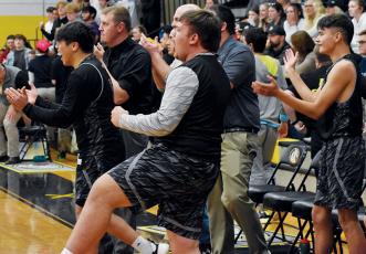 Members of the Robbinsville Black Knights erupt in celebration at the final buzzer Tuesday, which cemented a 68-64 Robbinsville victory at Murphy. Photos by Kevin Hensley/sports@grahamstar.com
