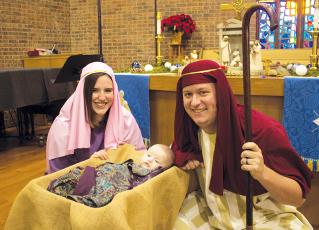 Kelsey Cody (Mary), 7-month-old Nora Grace Cody (Jesus) and Brady Cody (Joseph) as the Holy Family, which will be a part of Robbinsville United Methodist Church’s first-ever Christmas Extravaganza on Sunday. Photo by Charlie Benton/news@grahamstar.com
