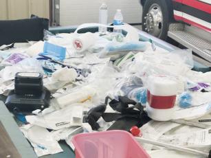 Discarded medical supplies are piled on the floor at the Graham County Emergency Services garage on Fort Hill Road. A whistle blower complaint alleges that some of the supplies were misidentified as being past their expiration date due to labels being misunderstood.