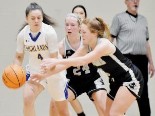 Robbinsville’s Kensley Phillips (24) and Halee Anderson apply heavy pressure to Highlands’ Julia Schmitt during Jan. 20’s road victory. Photo by Kevin Hensley/sports@grahamstar.com