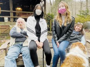 From left, host Rob Mason, exchange students Seoyun Choi and Giorgia Magnani, and host Robin Mason gather for a picture beside West Buffalo Creek. The dog’s name is Tucker. Photos by Randy Foster/news@grahamstar.com