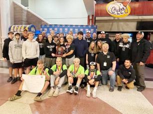 Several members of the Robbinsville wrestling program gather in the Greensboro Coliseum concourse Saturday night, posing with the 1A Invitational Tournament Team Runner-Up plaque. Photo courtesy of Susan Crowe/Contributing Photographer