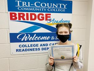 Shay Stewart poses with her high school equivalency diploma.