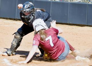 Robbinsville Middle School catcher Dreylee Webster applies the tag to a Swain County runner Friday. Photo by Kevin Hensley/sports@grahamstar.com