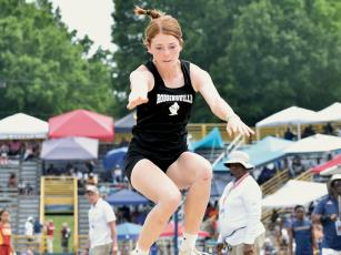 On this attempt, Lady Knights sophomore Zoie Shuler broke the 1A state record in the triple jump, setting a new standard of 39 feet, 9 ¼ inches at Saturday’s championship meet in Greensboro. It was her second state championship of the day. Photos by Kevin Hensley/sports@grahamstar.com