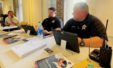 EMT Hamilton Boxberger, sheriff’s Detective Andrew Bennett and Sheriff’s Capt. Jeff Knight (from left) provide information about services their agencies provide  during the Adult Services Resource Fair on June 15 in Robbinsville. Photo by Randy Foster/news@grahamstar.com