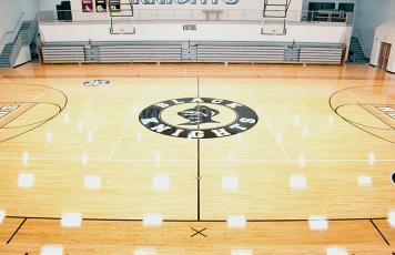 Lights glisten while showcasing the restored floor inside the Robbinsville High School gymnasium. The effort took a mere three weeks to complete. Photo by Kevin Hensley/sports@grahamstar.com