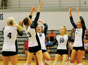 Robbinsville’s Kensley Phillips, Claire Barlow, Desta Trammell, Suri Watty and Delaney Brooms (from left) celebrate after a kill during Tuesday’s home opener against Asheville Christian Academy. Photo by Miranda Buchanan/Robbinsville High School Yearbook
