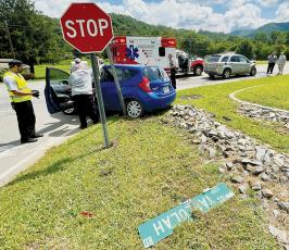 Emergency personnel attend to Martha Carpenter, whose car was involved in a collision at the intersection of Woodland Heights Road and Tallulah Road (U.S. Hwy. 129) around noon July 28. Photo by Randy Foster/news@grahamstar.com