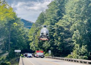 A life-flight helicopter takes off from the West Buffalo Creek bridge – just below the Cherohala Skyway – on Aug. 23, after a motorcycle crash. Photo by Randy Foster/news@grahamstar.com