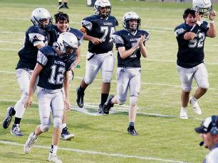 Members of the JV Black Knights – Tillman Adams (12), Kasen Buchanan, Isiac Collins, John Dominguez-Romero (74), Matthew Phillips (7) and Kellen Ensley (52) – were all smiles while jogging off the field after Collins connected on a rare JV point-after during Robbinsville’s 59-6 romping of Andrews on Sept. 22. Photo by Miranda Buchanan/Robbinsville High School Yearbook